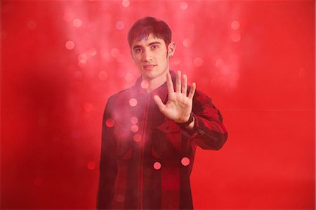 red background pic men - Portrait of young man wearing checked shirt Stock Photo - Premium Royalty-Free, Code: 614-06896906