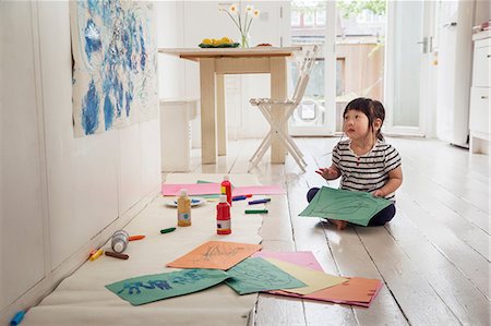 east asian ethnicity - Female toddler sitting on floor with drawings Stock Photo - Premium Royalty-Free, Code: 614-06896951