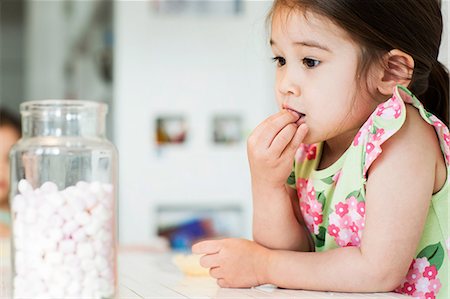 dress - Close up of young girl tasting marshmallows Stock Photo - Premium Royalty-Free, Code: 614-06896963