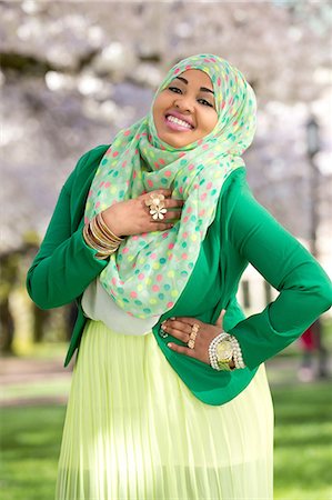 Portrait of young female in park wearing green Stock Photo - Premium Royalty-Free, Code: 614-06897043