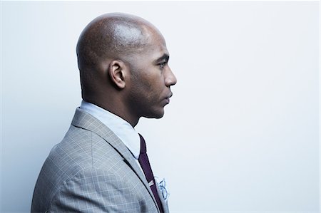 studio shot - Studio portrait of businessman in profile Photographie de stock - Premium Libres de Droits, Code: 614-06897218