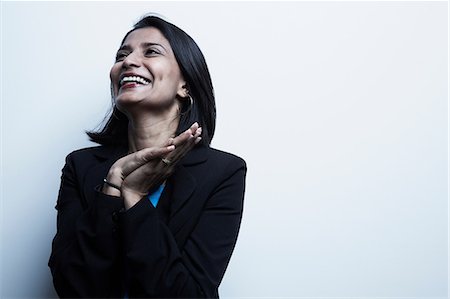 portrait people grey background - Studio portrait of businesswoman smiling Stock Photo - Premium Royalty-Free, Code: 614-06897223