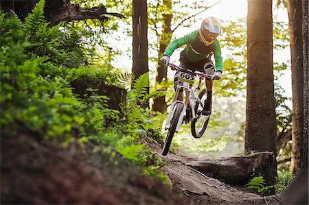people balancing bicycle picture - Mountain biker riding through woods Stock Photo - Premium Royalty-Free, Code: 614-06897288