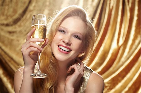 retro fun - Candid portrait of young woman holding champagne flute Stock Photo - Premium Royalty-Free, Code: 614-06897302