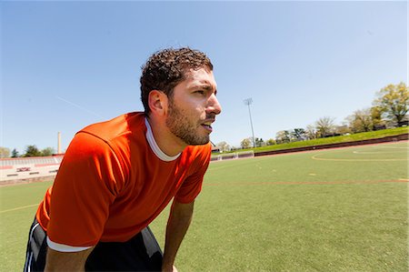 Soccer player taking a break on pitch Foto de stock - Sin royalties Premium, Código: 614-06897428