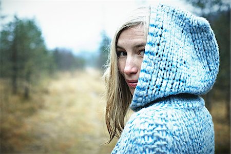 person with hood - Woman wearing hooded top in forest Stock Photo - Premium Royalty-Free, Code: 614-06897527