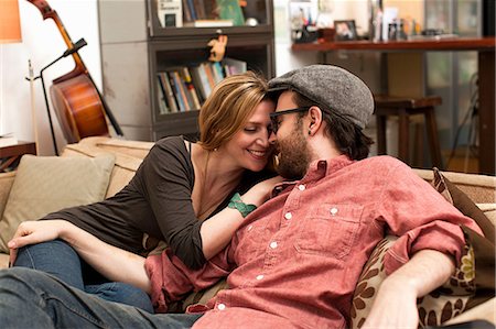 relaxing at home - Couple kissing on sofa Stock Photo - Premium Royalty-Free, Code: 614-06897569