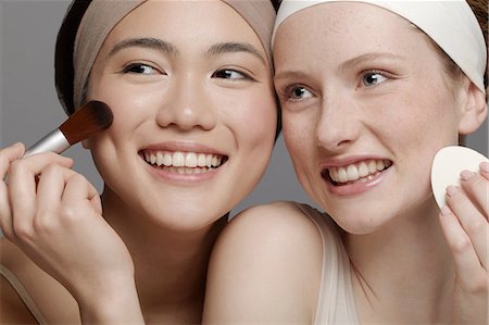 Young women putting on make up Stock Photo - Premium Royalty-Free, Code: 614-06897577