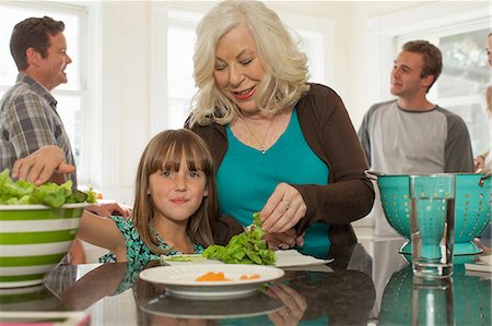 Granddaughter and grandmother preparing salad Stock Photo - Premium Royalty-Free, Code: 614-06897657