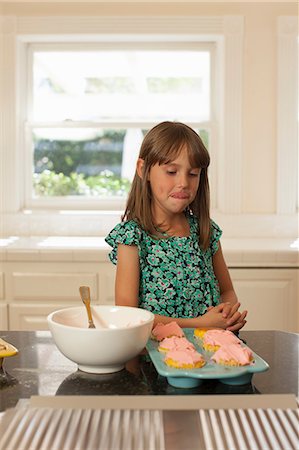 Young girl looking at cupcakes, licking lips Stock Photo - Premium Royalty-Free, Code: 614-06897670