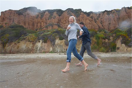 picture of women on california beaches - Mature couple running on beach Stock Photo - Premium Royalty-Free, Code: 614-06897716