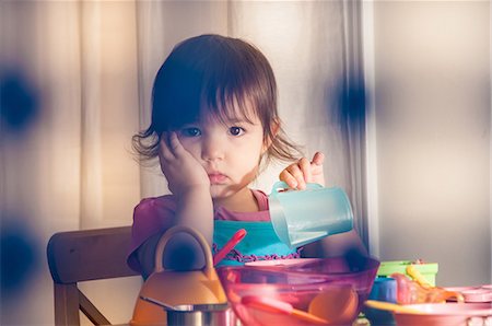 sad lonely girl - Sad girl playing with toys Stock Photo - Premium Royalty-Free, Code: 614-06897710