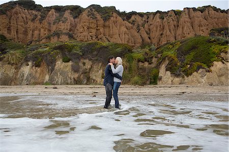 full length lady - Mature couple standing in sea kissing Stock Photo - Premium Royalty-Free, Code: 614-06897721