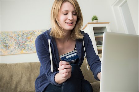 shopping at home - Young woman shopping online with credit card Stock Photo - Premium Royalty-Free, Code: 614-06897768