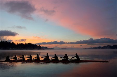 simsearch:614-09135005,k - Nine people rowing at sunset Fotografie stock - Premium Royalty-Free, Codice: 614-06897795