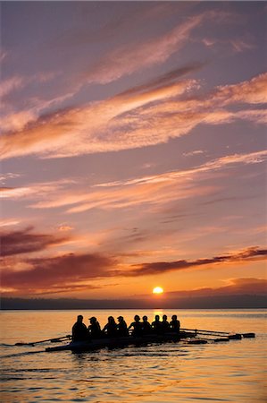 Eight people rowing at sunset Stock Photo - Premium Royalty-Free, Code: 614-06897796