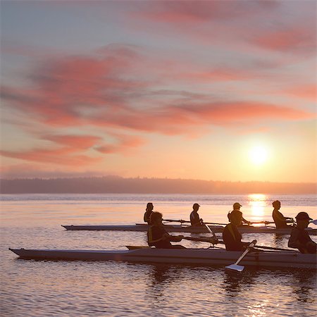 simsearch:614-09135006,k - Seven people rowing at sunset Fotografie stock - Premium Royalty-Free, Codice: 614-06897802