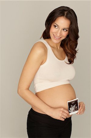 studio shot - Pregnant woman holding ultrasound scan Stock Photo - Premium Royalty-Free, Code: 614-06897859