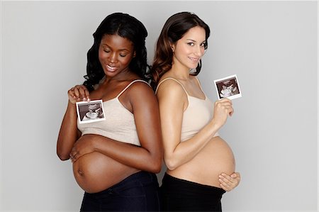 Two pregnant women holding ultrasound scans Stock Photo - Premium Royalty-Free, Code: 614-06897867