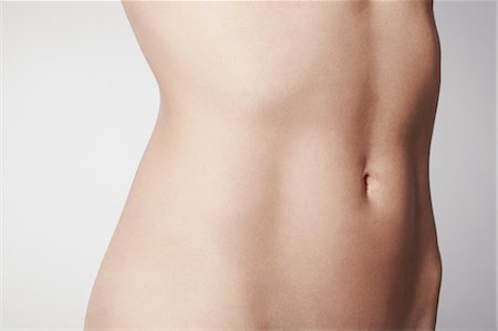 stomach (upper abdomen) - Slim young woman's midriff Stock Photo - Premium Royalty-Free, Code: 614-06897871