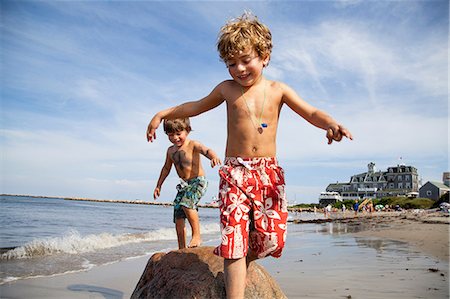 swim shorts for boys - Two boys playing on beach Stock Photo - Premium Royalty-Free, Code: 614-06898005