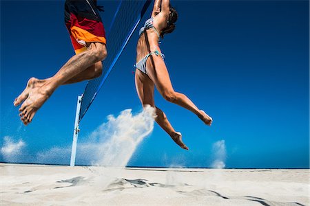 feet in the air - Two beach volleyball players blocking at net Stock Photo - Premium Royalty-Free, Code: 614-06898045