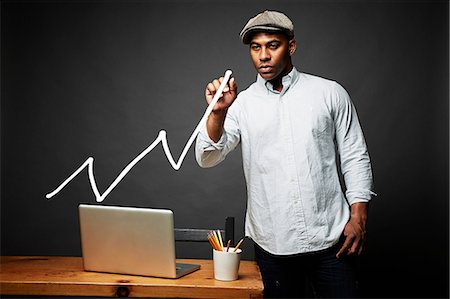pictograph - Man drawing line graph Stock Photo - Premium Royalty-Free, Code: 614-06898188