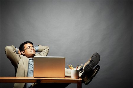 sit adult business studio full length - Man relaxing with feet up on table Stock Photo - Premium Royalty-Free, Code: 614-06898223