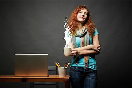 Woman enjoying cup of steaming hot beverage Stock Photo - Premium Royalty-Free, Code: 614-06898237