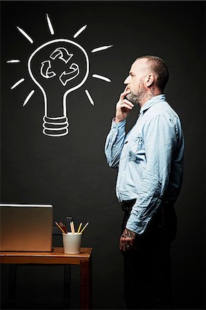 environmental business - Man contemplating on recycling idea Stock Photo - Premium Royalty-Free, Code: 614-06898243