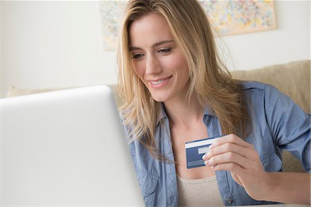 Woman holding credit card Stock Photo - Premium Royalty-Free, Code: 614-06898295