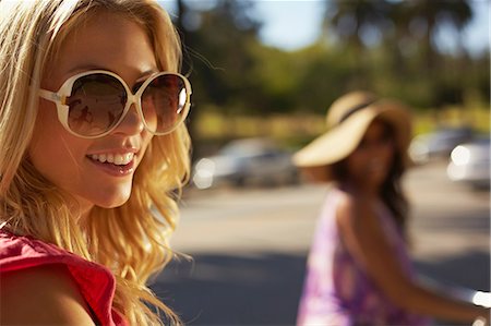 person with sunglasses - Women on bicycle laughing Stock Photo - Premium Royalty-Free, Code: 614-06898325