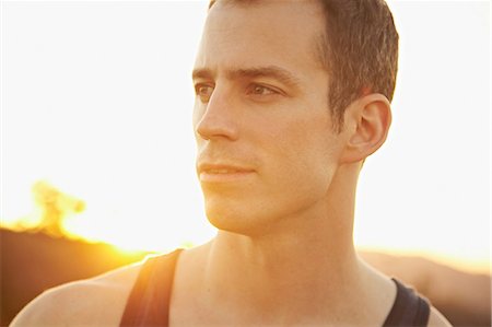 evening sunlight - Man in singlet looking into distance Stock Photo - Premium Royalty-Free, Code: 614-06898375