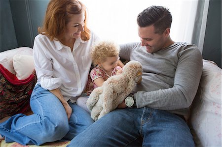 stuffed animal to baby - Husband & wife entertaining child Stock Photo - Premium Royalty-Free, Code: 614-06898406