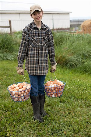 rubber boots - Boy carrying two baskets of eggs Stock Photo - Premium Royalty-Free, Code: 614-06898460