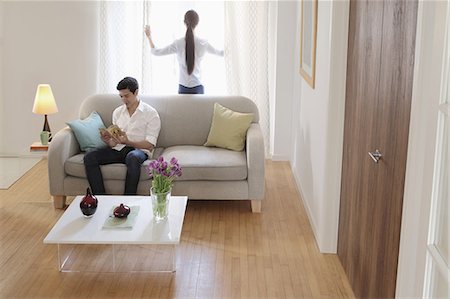 sofa back view - Husband and wife relaxing in living room Stock Photo - Premium Royalty-Free, Code: 614-06898601