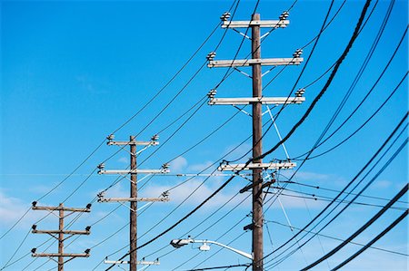 simsearch:632-05992131,k - Cables attached to telegraph pole against blue sky Stock Photo - Premium Royalty-Free, Code: 614-06974172