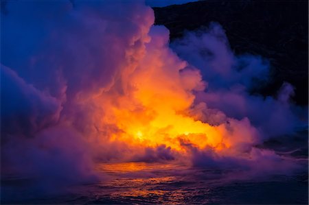 Smoke clouds from lava flow impacting sea at dusk, Kilauea volcano, Hawaii Stock Photo - Premium Royalty-Free, Code: 614-06974284