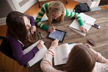 Girls sitting at table studying Stock Photo - Premium Royalty-Free, Code: 614-06974340