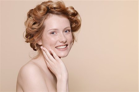 Young woman with curly red hair, portrait Stock Photo - Premium Royalty-Free, Code: 614-06974564