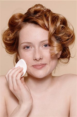 simsearch:614-06974550,k - Portrait of young woman cleaning face with cotton wool Stock Photo - Premium Royalty-Free, Code: 614-06974561