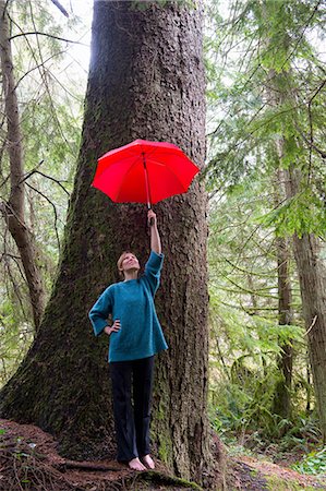 simsearch:614-06974601,k - Mature woman holding red umbrella in forest Stock Photo - Premium Royalty-Free, Code: 614-06974593