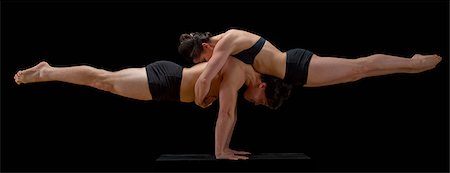 Mid adult dancers performing together in front of black background Stock Photo - Premium Royalty-Free, Code: 614-06974608