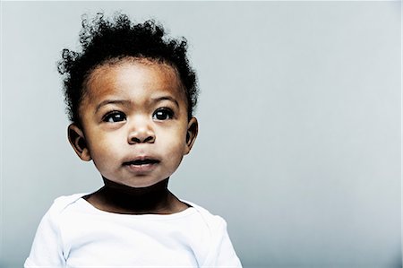 Portrait of baby boy wearing white vest Stock Photo - Premium Royalty-Free, Code: 614-06974662