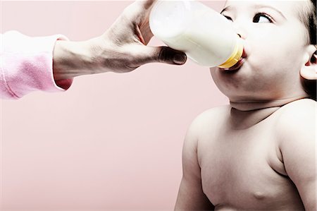 senior and baby - Portrait of baby girl drinking milk from bottle Stock Photo - Premium Royalty-Free, Code: 614-06974700
