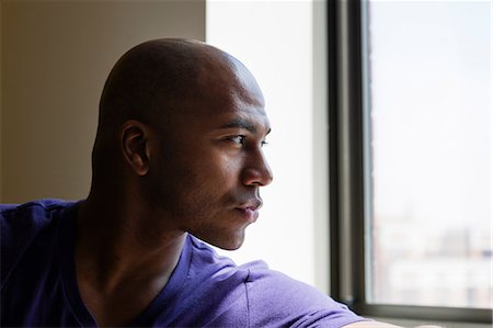 purple people - Close up portrait of mid adult male looking out of window Stock Photo - Premium Royalty-Free, Code: 614-06974760