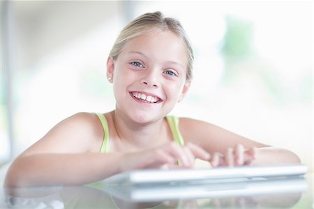 Girl using digital tablet Stock Photo - Premium Royalty-Free, Code: 614-06973532