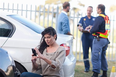 four women car - Woman photographing damage on her car at car accident scene Photographie de stock - Premium Libres de Droits, Code: 614-06973604