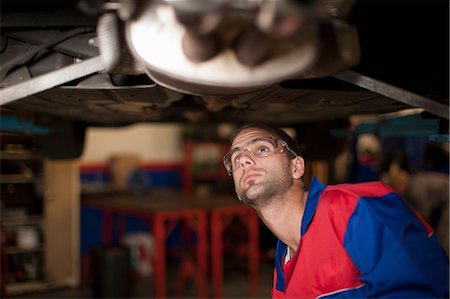 person in car interior - Car mechanic at work in service bay Stock Photo - Premium Royalty-Free, Code: 614-06973674
