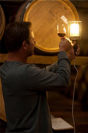 people dim light - Checking wine aging in barrels Stock Photo - Premium Royalty-Free, Code: 614-06973688